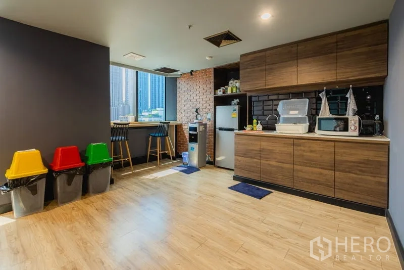Office Space for rent - Pantry with wood cabinetry, fridge, microwave and window bar seating.