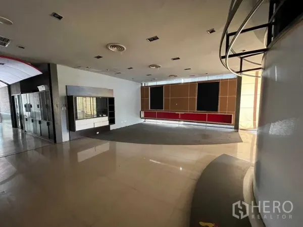 Retail Space for rent - Open retail floor with display counters, recessed lighting, tiled flooring and a large front window.