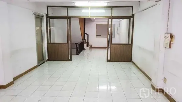 Home Office for rent or sale in Bang Na, Bangkok - Open-plan ground floor with glass partitions and a staircase.