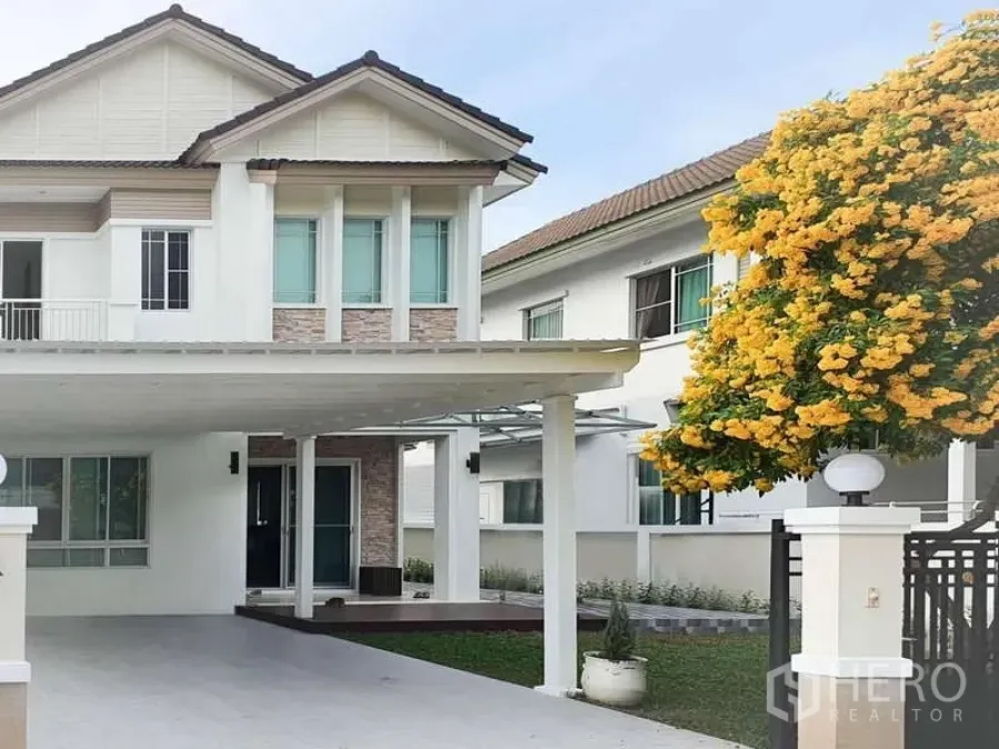 Detached House for rent in Sathon, Bangkok - Front facade of the house with wide carport and gated entrance.