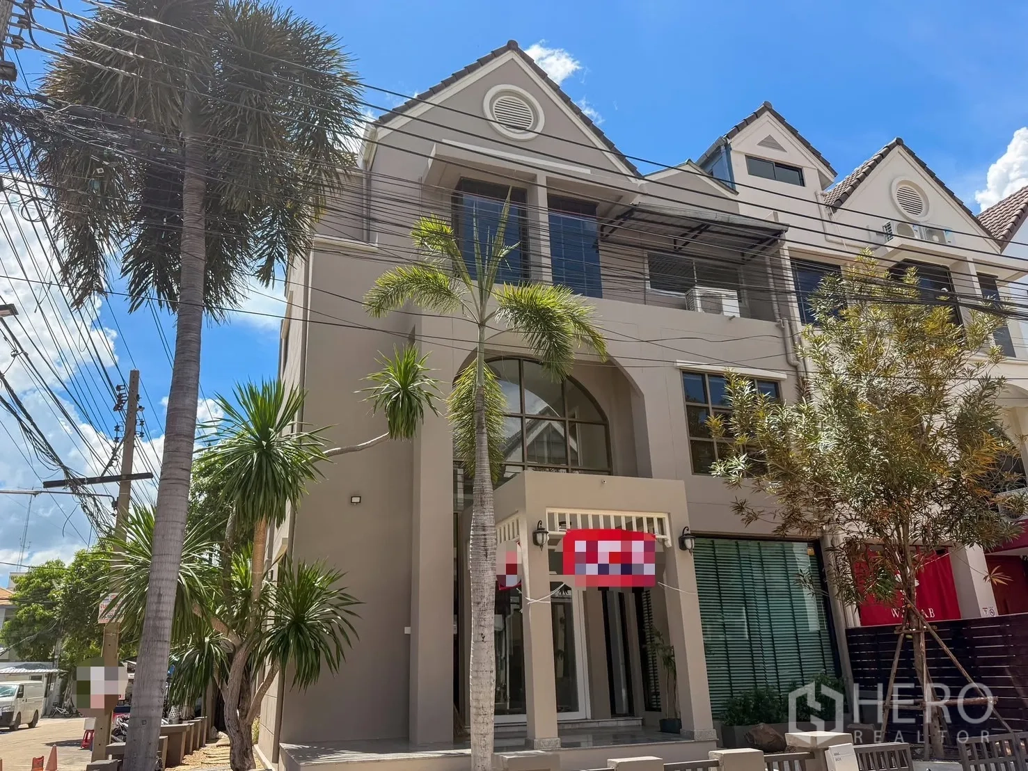 Home Office for rent in Wang Thonglang, Bangkok - Modern home office exterior with gable roof, tall windows and palm trees.