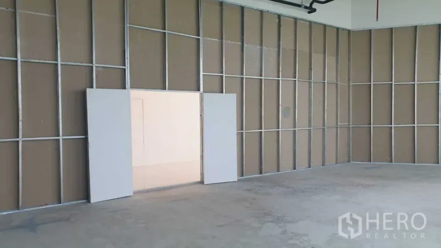 Retail Space for rent - Interior retail space with double doors to the common area and drywall framing.