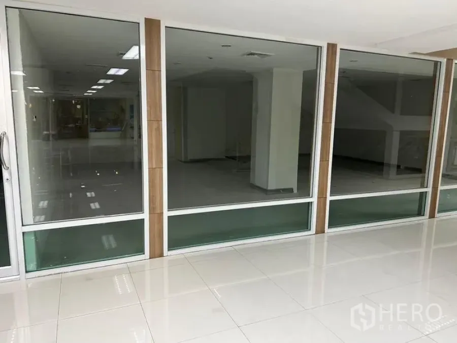Office Space for rent in Bang Rak, Bangkok - Full-height glass storefront of the office unit with sliding door and tiled walkway.