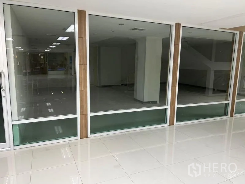 Office Space for rent in Bang Rak, Bangkok - Full-height glass storefront of the office unit with sliding door and tiled walkway.
