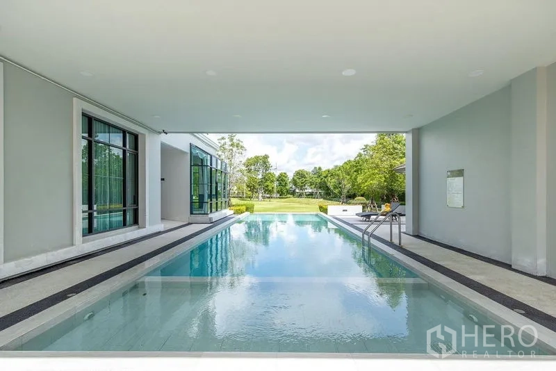 Detached House for rent in Bang Phli, Samut Prakan - Covered communal swimming pool with deck and views of landscaped gardens.