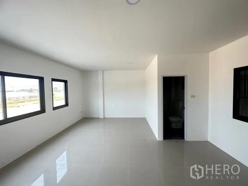 Factory for rent or sale in Bang Bua Thong, Nonthaburi - Bright upper‑floor office with tiled floors, windows and a private restroom.