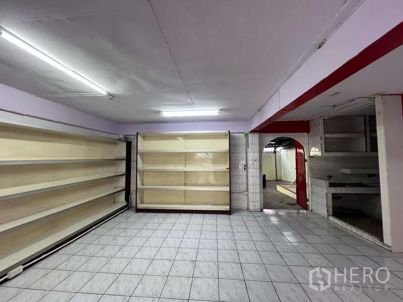 Shophouse for rent in Suan Luang, Bangkok - Storage or display room with built-in shelving and tiled floor.