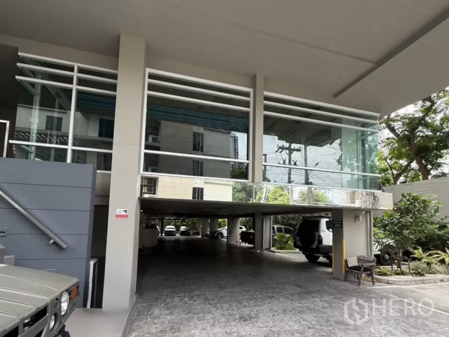 Retail Space for rent in Watthana, Bangkok - Modern building entrance with glass facade and covered parking in Ekkamai, Bangkok.