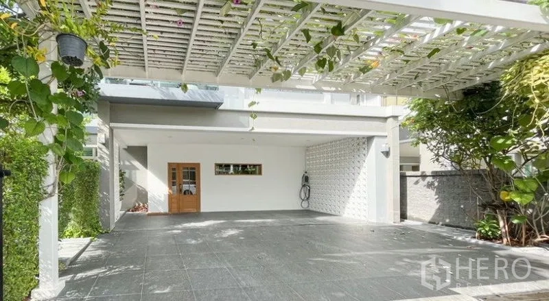Detached House for rent - Covered carport with white pergola and climbing plants, offering multiple parking spaces and a side gate.