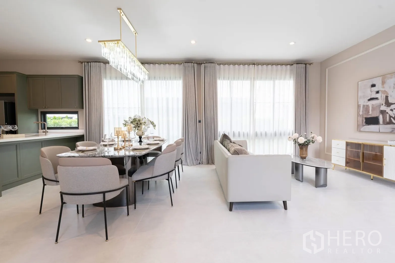 Detached House for rent in Bang Phli, Samut Prakan - Dining room beside light-gray kitchen with island and floor-to-ceiling drapes.