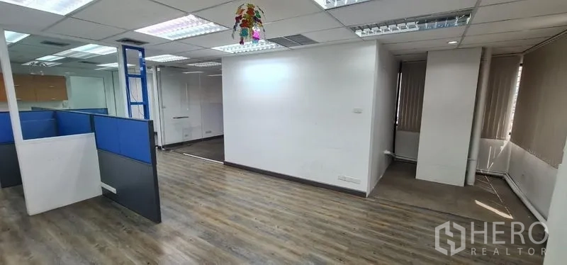 Office Space for rent in Watthana, Bangkok - Open plan area with cubicles, white walls, and a dropped ceiling.