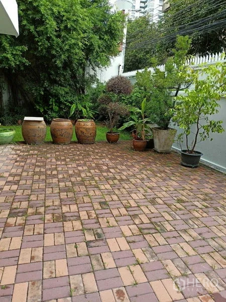 Home Office for rent in Watthana, Bangkok - Paved patio with large ceramic planters and small garden.
