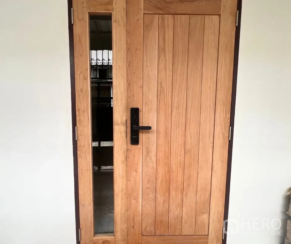 Townhouse for rent - Solid wood front door with digital lock and side glass panel.