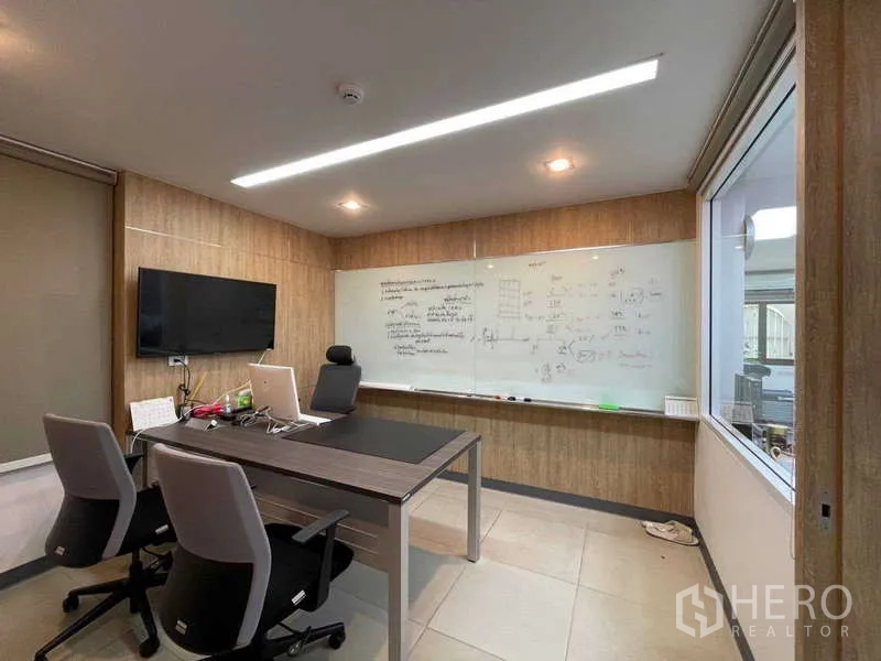 Home Office for rent in Watthana, Bangkok - Executive office with large whiteboard wall, TV and two chairs.