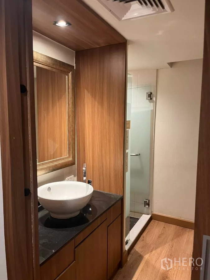 Office Space for rent - Modern restroom with wood cabinetry, vessel sink and a glass shower.