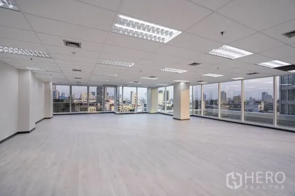 Office Space for rent in Bang Rak, Bangkok - Bright corner office with full-height windows, city skyline views and LED grid lighting in Silom CBD.