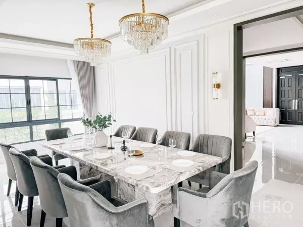 Detached House for rent or sale in Bang Phli, Samut Prakan - Second view of the dining room showing twin chandeliers, large windows and connection to the lounge.