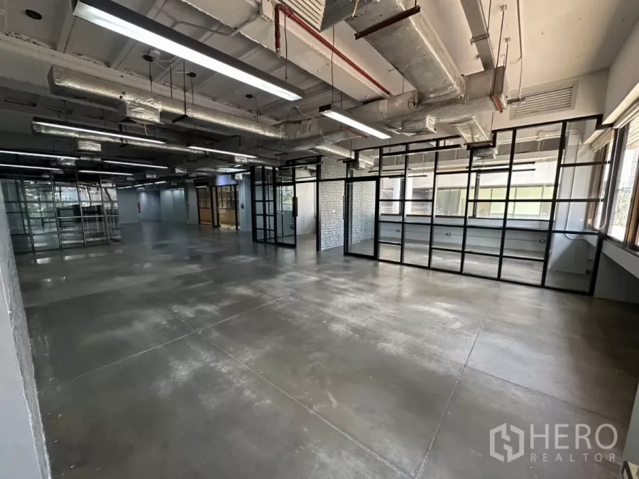 Office Space for rent - Spacious workspace with floor-to-ceiling grid glass wall and LED strip lighting.