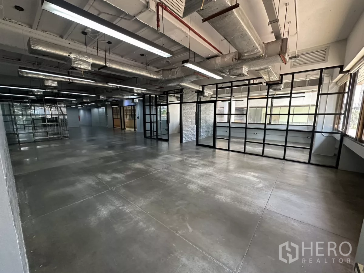 Office Space for rent - Spacious workspace with floor-to-ceiling grid glass wall and LED strip lighting.