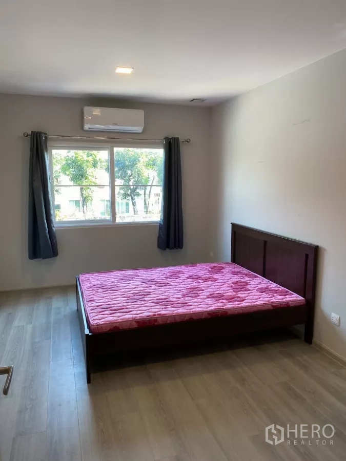 Detached House for rent in Prawet, Bangkok - Spacious second bedroom with large window, AC and bed frame.