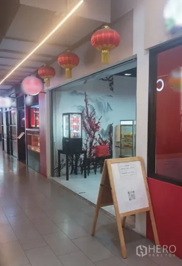 Retail Space for rent in Watthana, Bangkok - Glass-front retail shop with red lantern décor and display cabinets along an indoor mall corridor in Asok.
