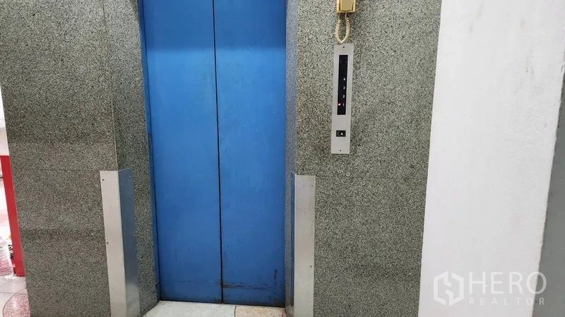 Office Space for rent or sale in Khlong Toei, Bangkok - Blue elevator doors inside the office building lobby.