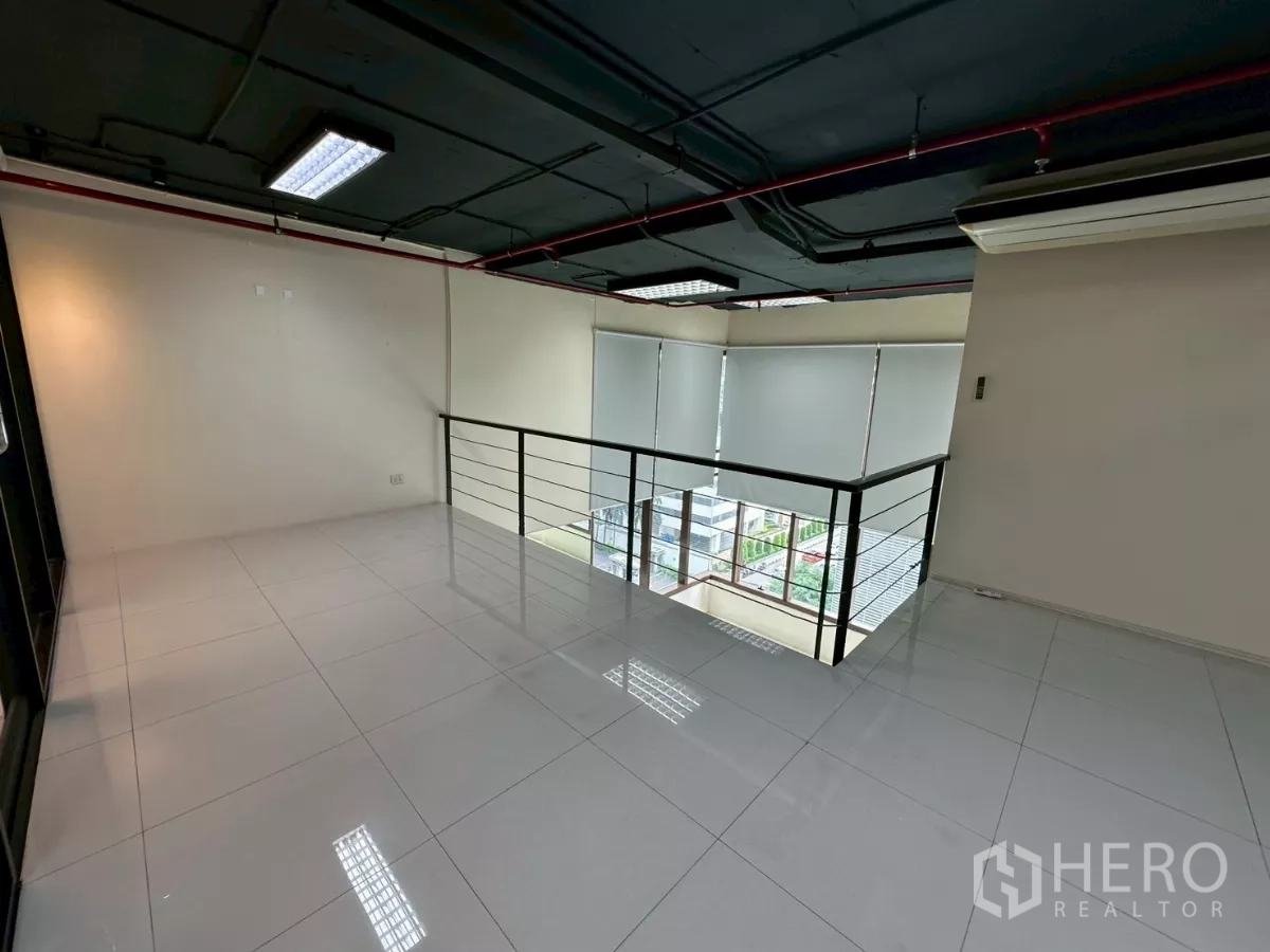 Office Space for rent in Khlong Toei, Bangkok - Mezzanine open space with railing overlooking the double-height area below.