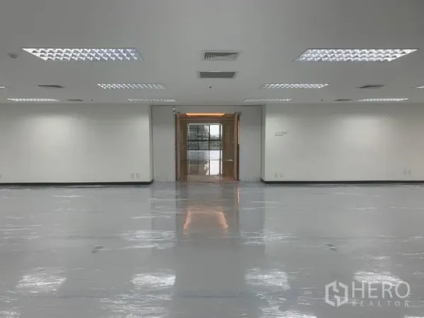 Office Space for rent in Bang Rak, Bangkok - Interior view from the office toward the lobby entrance with bright ceiling panels.