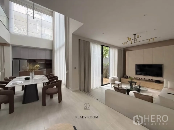 Detached House for rent in Bang Kapi, Bangkok - Open living and dining space with tall windows and sliding door to the patio.