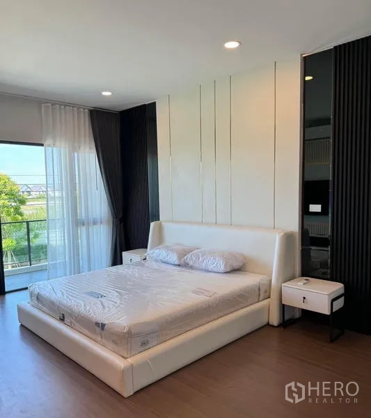 Detached House for rent or sale in Bang Phli, Samut Prakan - Bedroom with white bed, sliding glass doors to a balcony, and green views.