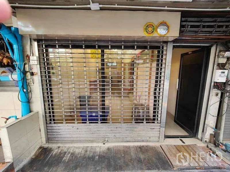 Retail Space for rent in Khlong Toei, Bangkok - Street-level shopfront with rolling security shutter and sliding glass doors.