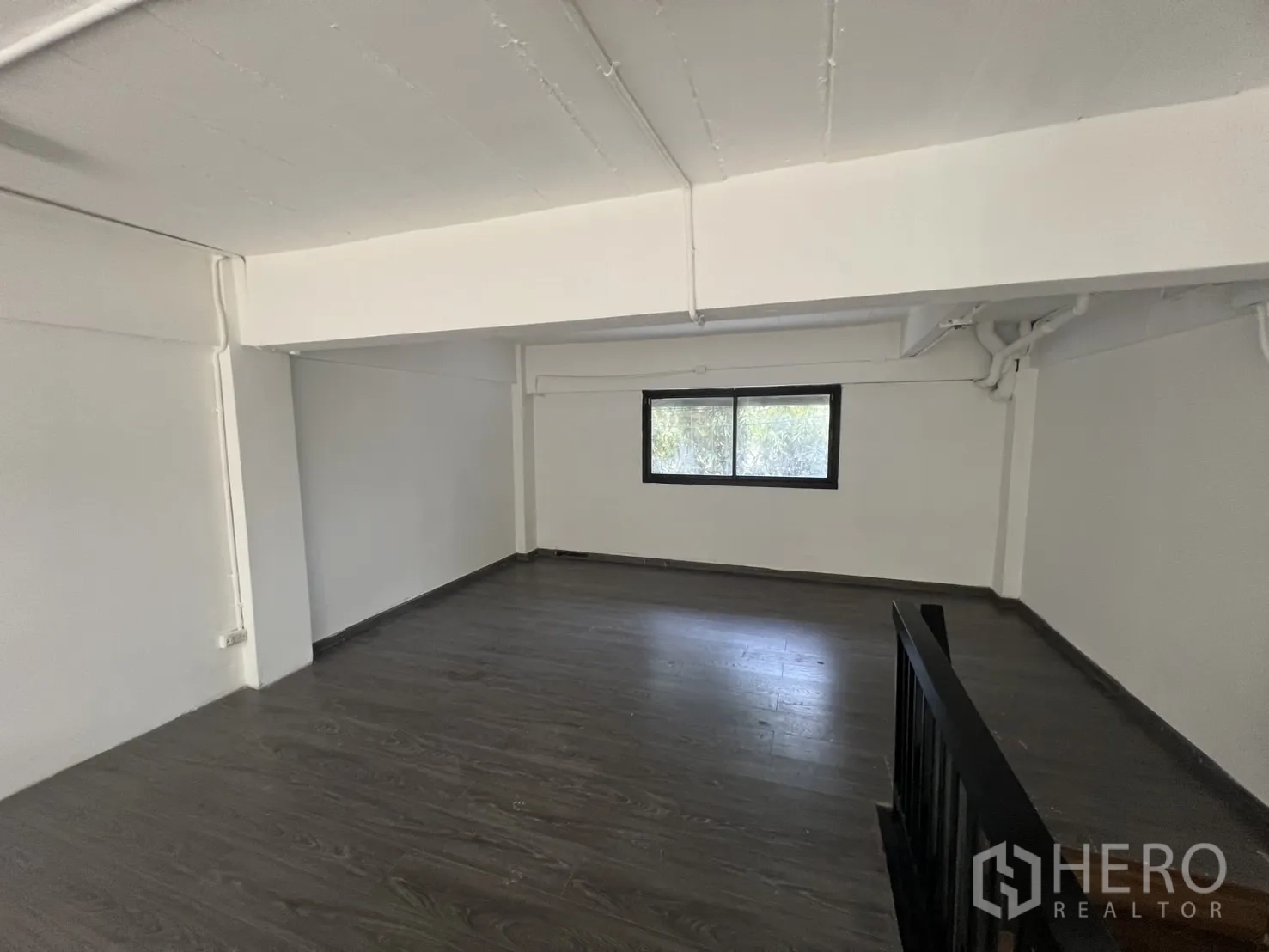 Retail Space for rent in Watthana, Bangkok - Upper level room with window and wood flooring, suitable for seating, office, or storage.