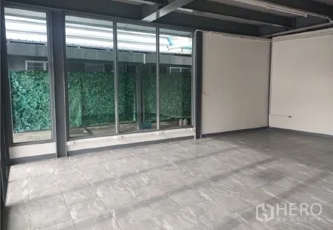 Retail Space for rent in Khlong Toei, Bangkok - Glass wall facing a green privacy screen, bringing natural light into the shop.