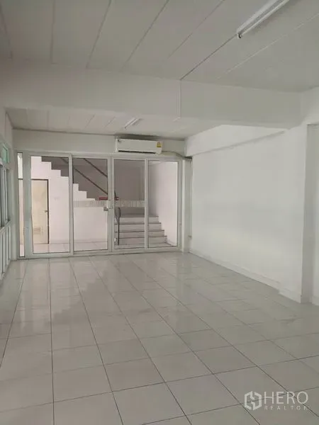 Warehouse for rent in Bang Phli, Samut Prakan - Clean office room with glass wall and staircase access within the warehouse complex.
