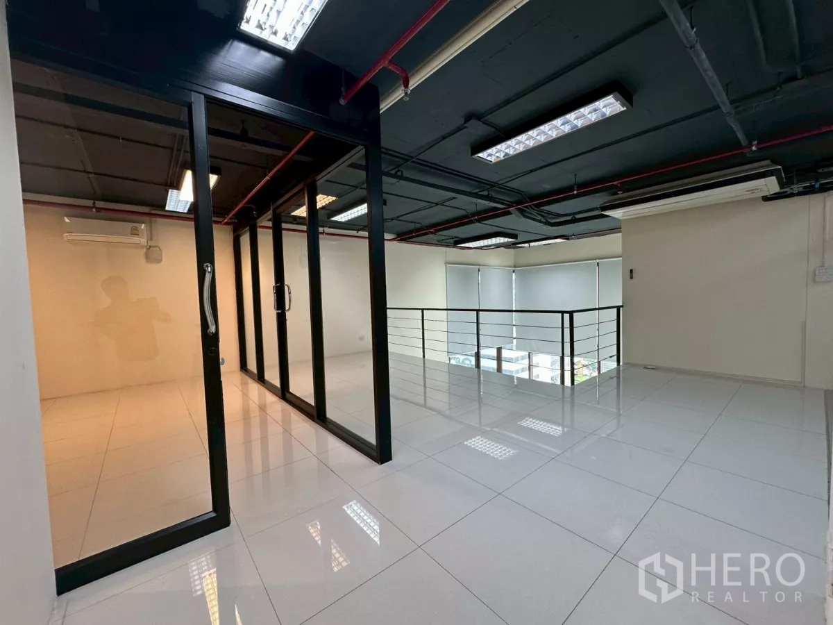 Office Space for rent in Khlong Toei, Bangkok - Mezzanine corridor outside the glass meeting room with blinds and city outlook.