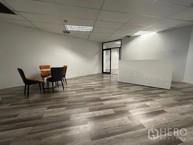 Office Space for rent or sale in Din Daeng, Bangkok - Lobby with reception counter and casual seating near glass doors in minimalist style.