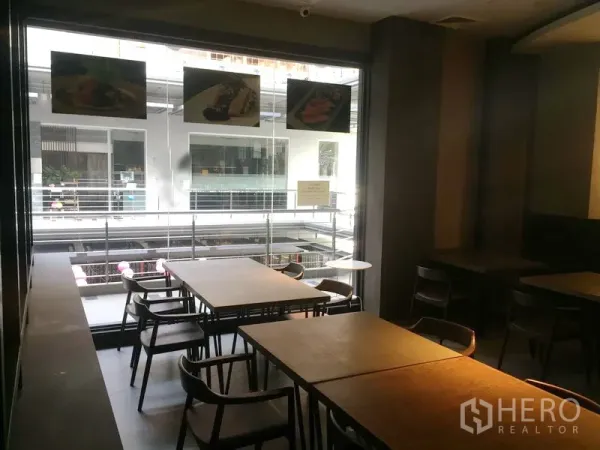 Retail Space for rent in Khlong Toei, Bangkok - Dining zone beside a large window and balcony overlooking an internal mall walkway.
