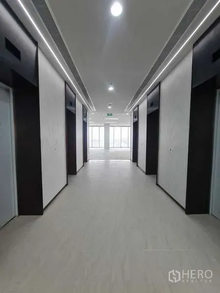 Office Space for rent in Chatuchak, Bangkok - Modern elevator lobby with multiple lifts and bright corridor lighting.