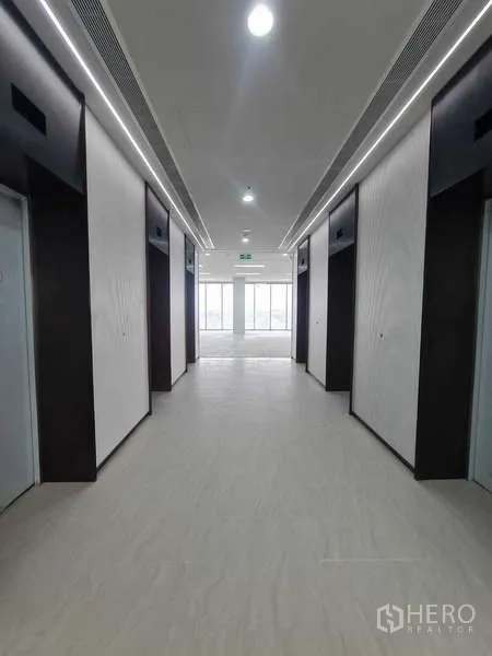 Office Space for rent in Chatuchak, Bangkok - Modern elevator lobby with multiple lifts and bright corridor lighting.