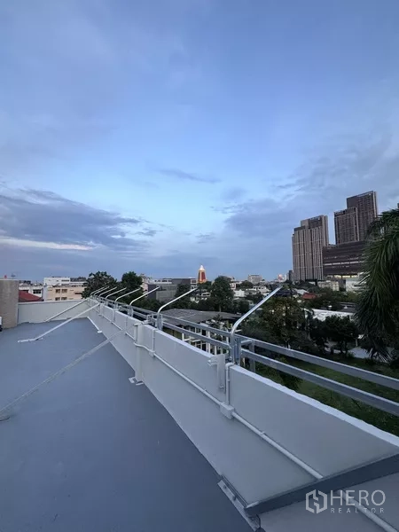 Shophouse for rent - Open rooftop view toward the Bangkok skyline and nearby high‑rises from the shophouse.