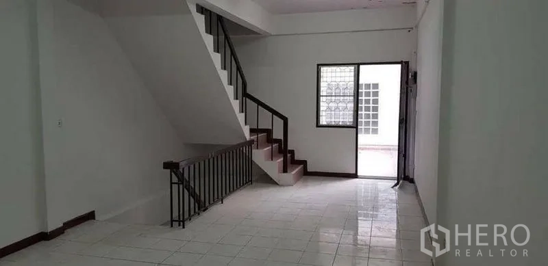Home Office for rent or sale in Bang Na, Bangkok - Open workspace with internal staircase and a side windowed door.