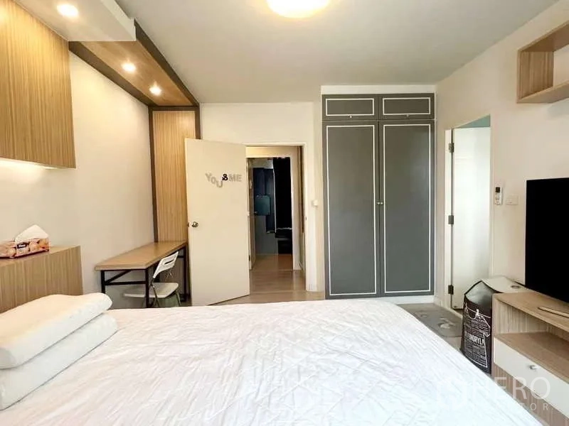 Detached House for rent in Bang Phli, Samut Prakan - Bedroom view showing tall grey wardrobe, work desk and doorway to the hall.