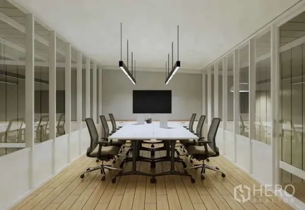 Warehouse for rent in Prawet, Bangkok - Glass-partitioned office meeting room with a long table, task chairs and pendant lights.