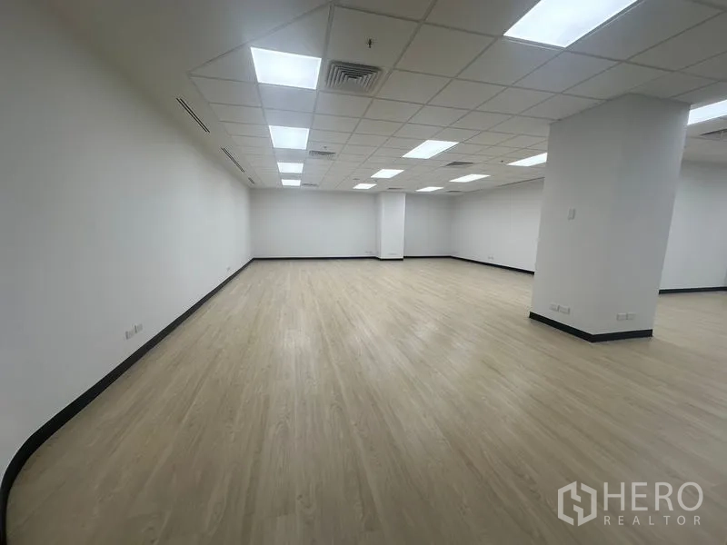 Office Space for rent in Chatuchak, Bangkok - Bright open-plan office with light wood flooring, white walls, and grid ceiling LED lights.