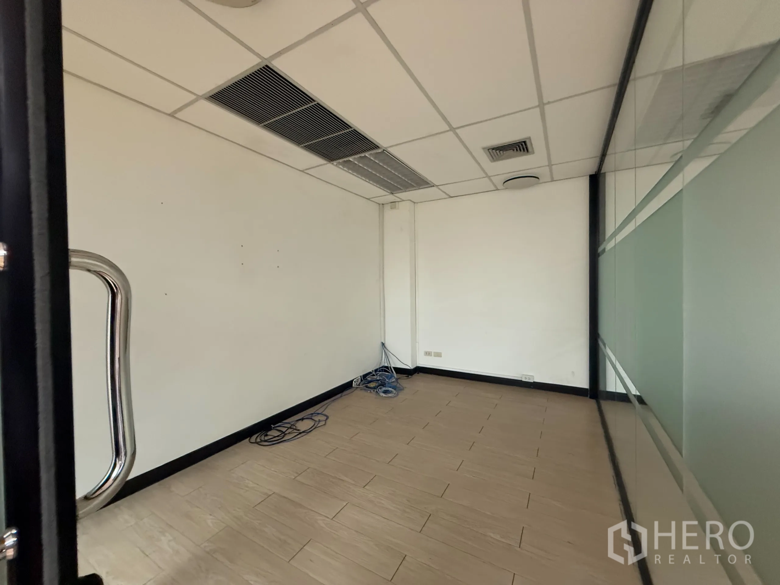 Office Space for rent - Compact office with glass wall, network cabling and suspended ceiling air vents.