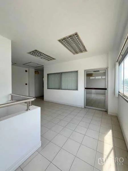 Warehouse for rent in Lat Krabang, Bangkok - Upper-floor landing with large windows and fluorescent lighting.