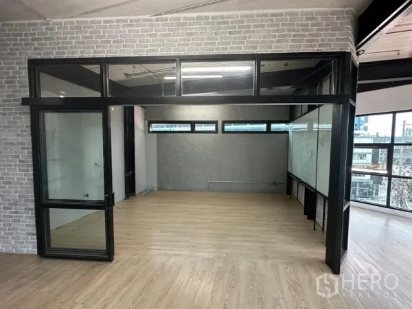 Office Space for rent in Chatuchak, Bangkok - Enclosed glass meeting room with clerestory windows and laminate wood floors.