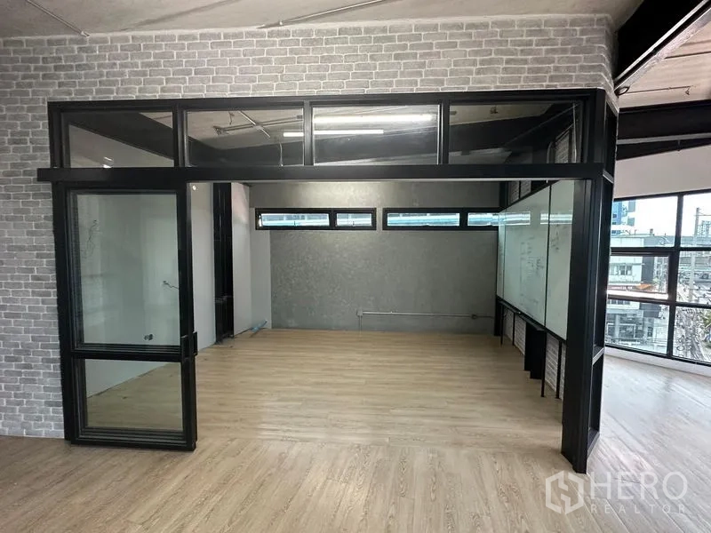 Office Space for rent in Chatuchak, Bangkok - Enclosed glass meeting room with clerestory windows and laminate wood floors.