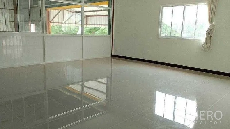 Warehouse for rent or sale in Nakhon Pathom - Bright office room with glossy tiled floor, windows and glass partitions overlooking the warehouse.