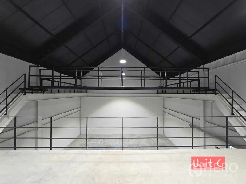 Home Office for rent in Chatuchak, Bangkok - Symmetrical view of twin mezzanine bridges beneath a pitched black ceiling.